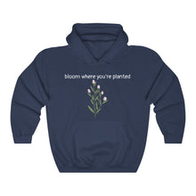 Load image into Gallery viewer, Navy Flourished Hoodie front side with text and pinky bud flower. 
