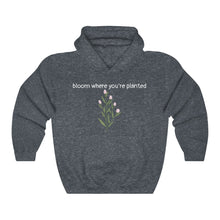 Load image into Gallery viewer, Heather Navy Flourished Hoodie front side with text and pinky bud flower. 
